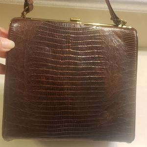 Vintage brown crocodile top handle bag with brass closure. One pocket inside.